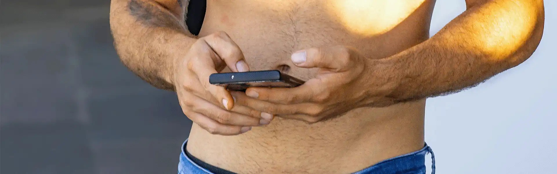 Hands holding a black smartphone.