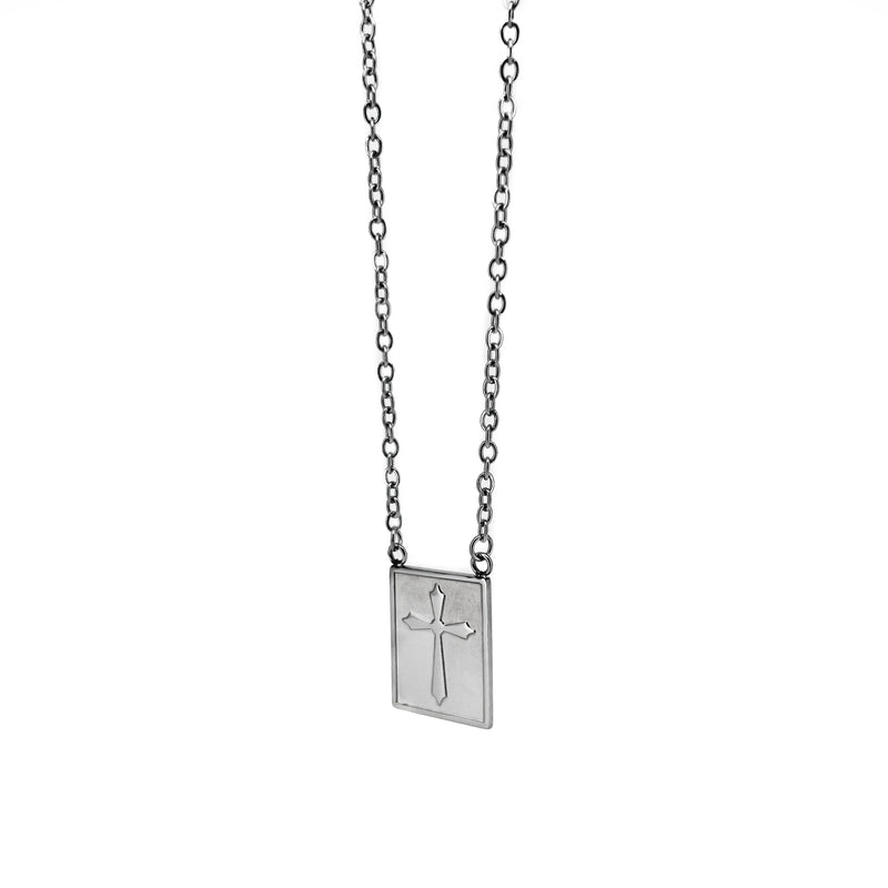 Silver pendant necklace featuring a rectangular charm with an engraved cross design.