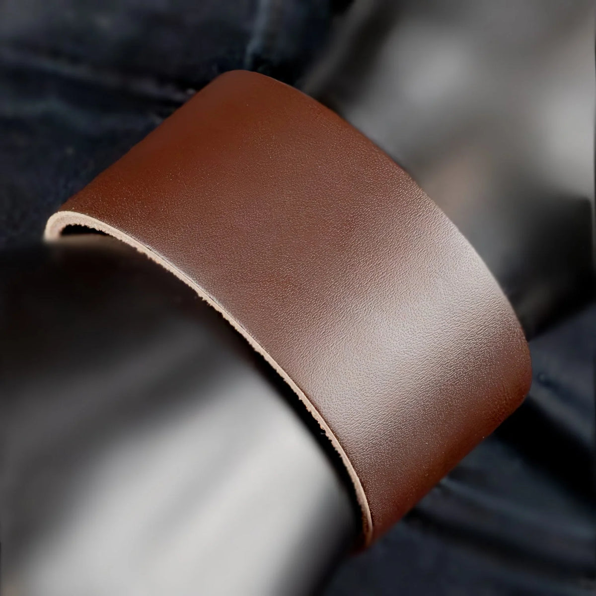 Curved strip of smooth brown leather.