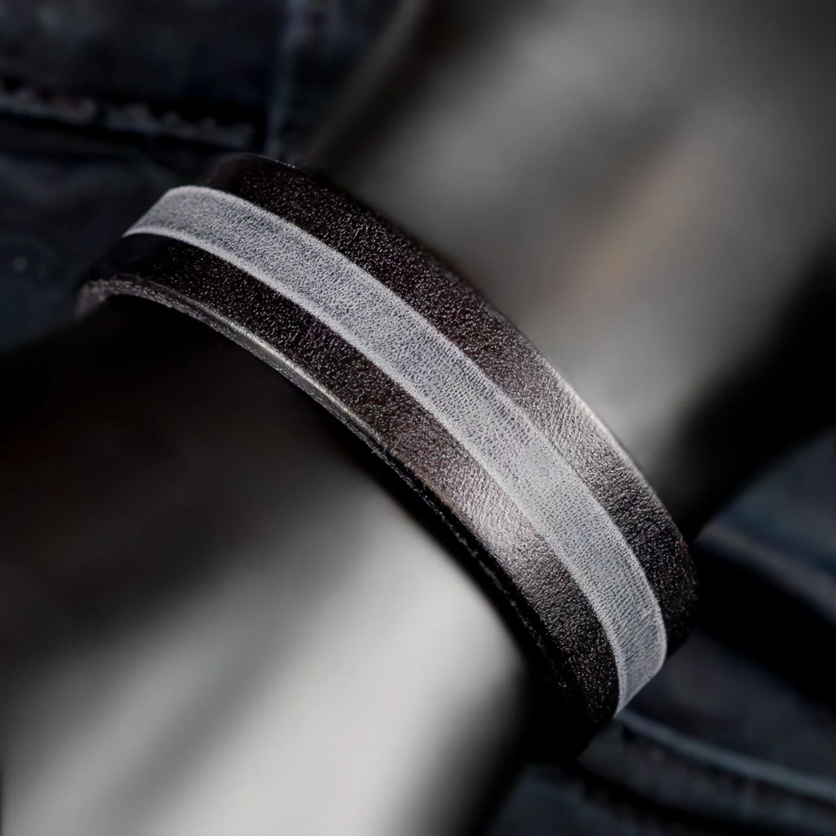 Two-toned metal ring with a brushed finish and contrasting dark and light bands.