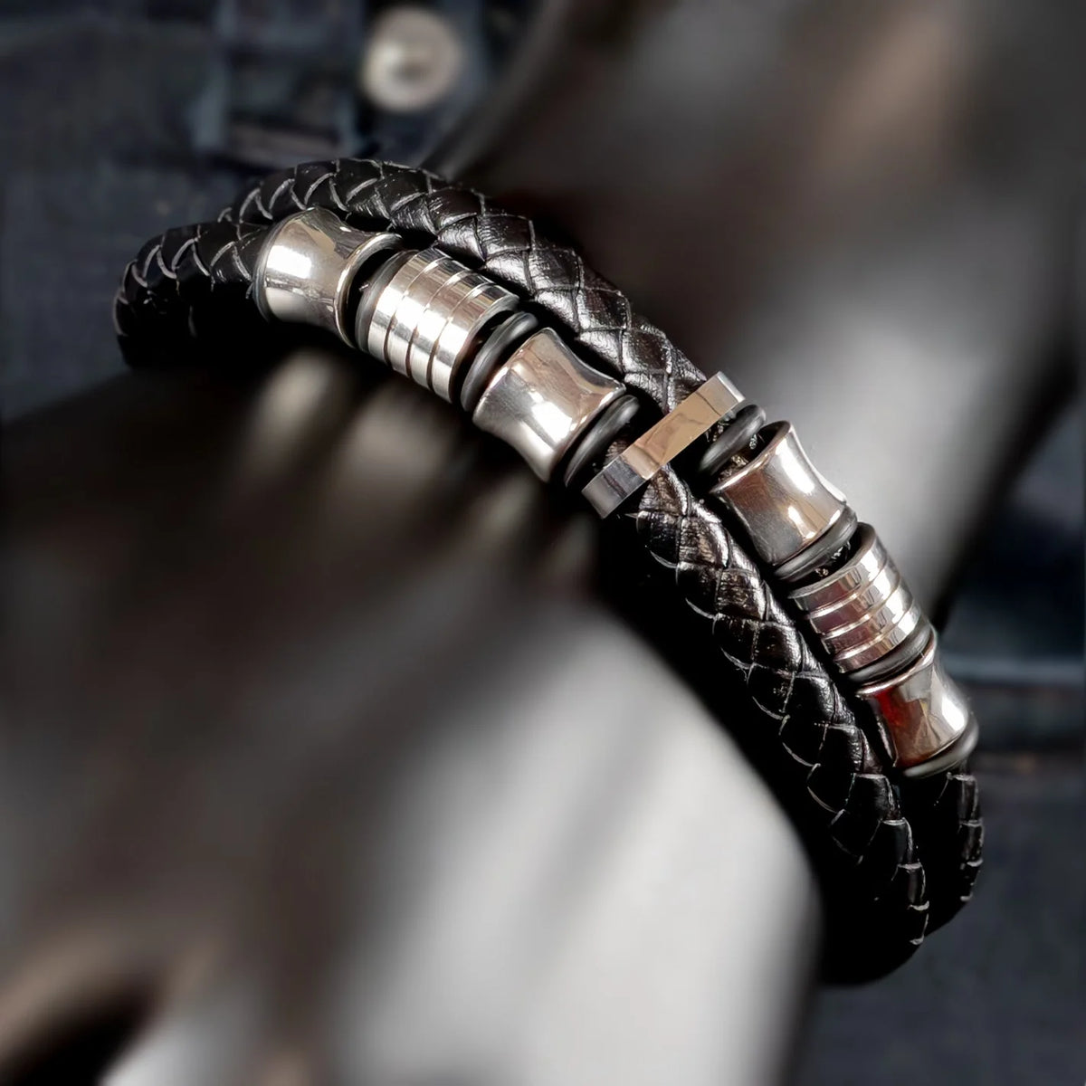 Black leather bracelet with silver metal accents and clasps.