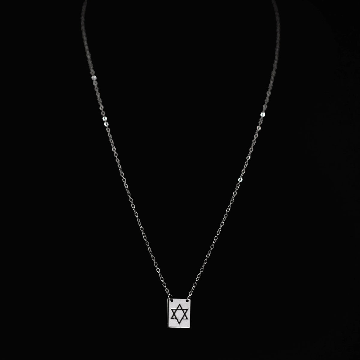 Necklace with a pendant featuring the Star of David symbol.