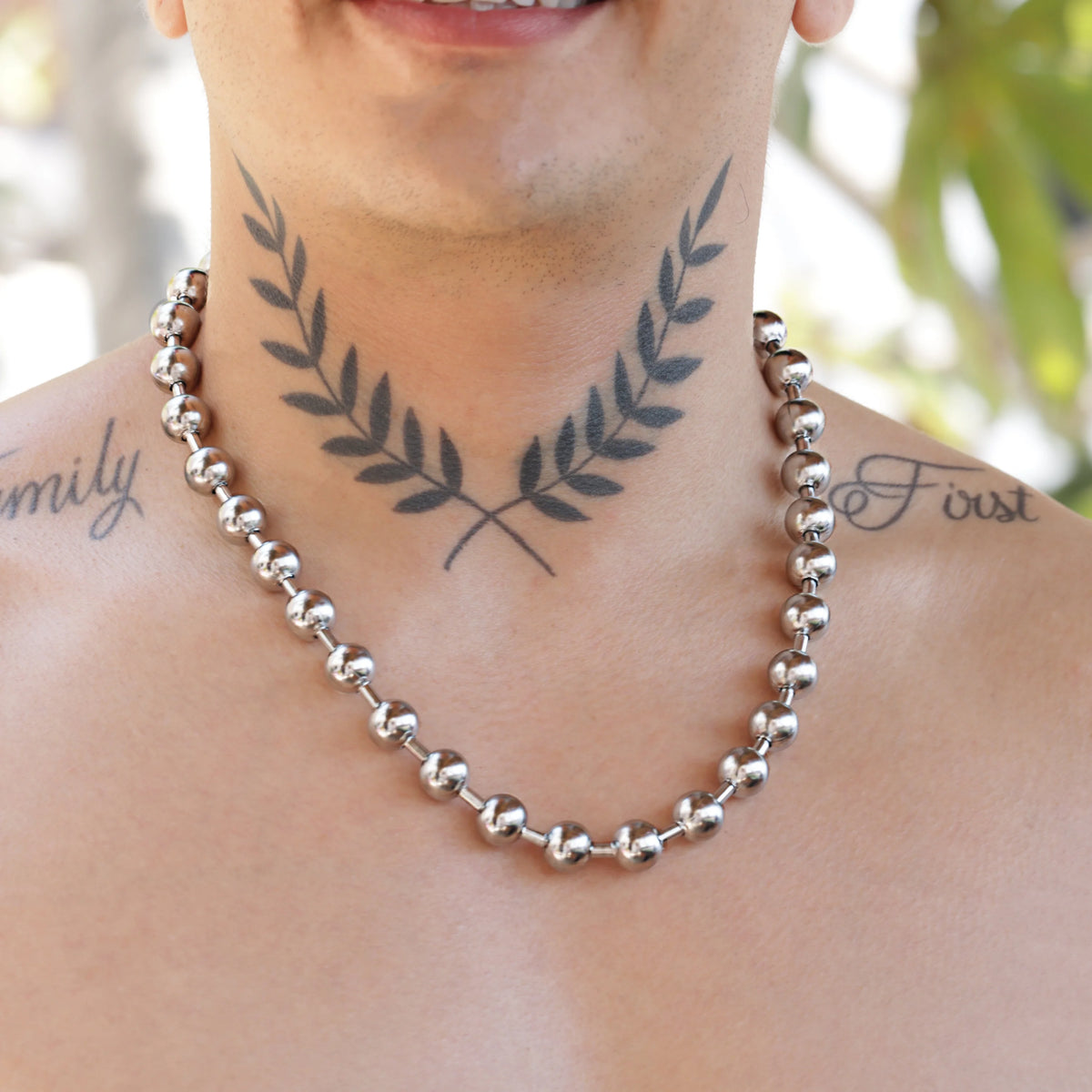 Silver beaded chain necklace with interconnected spherical links.