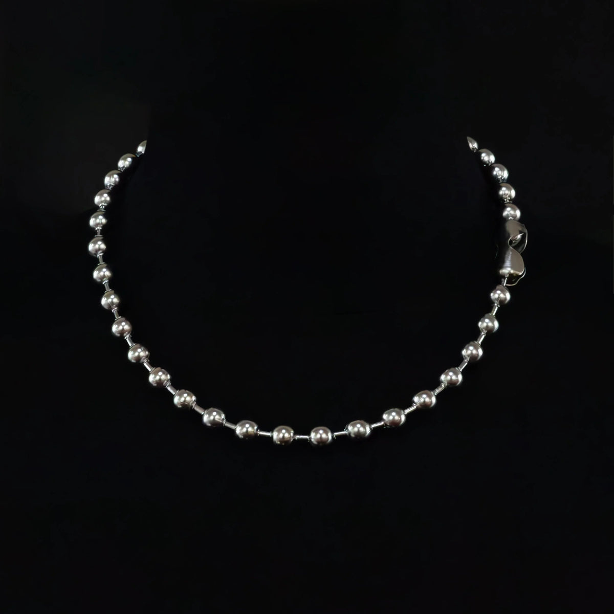 Silver bead necklace with a clasp.