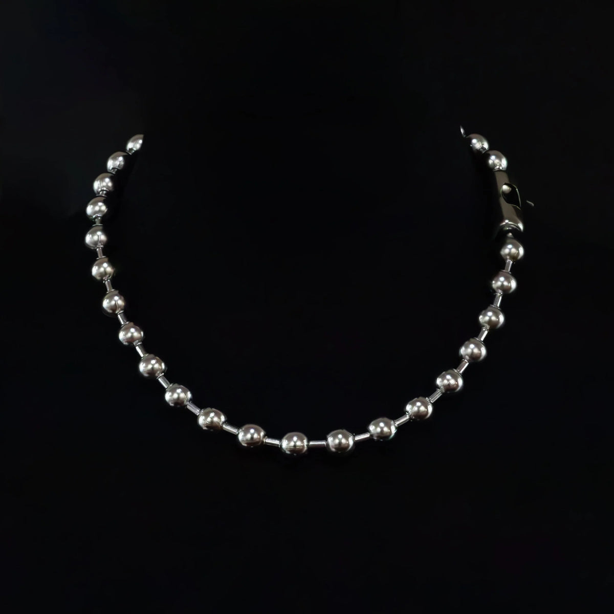 Silver bead necklace with a clasp.