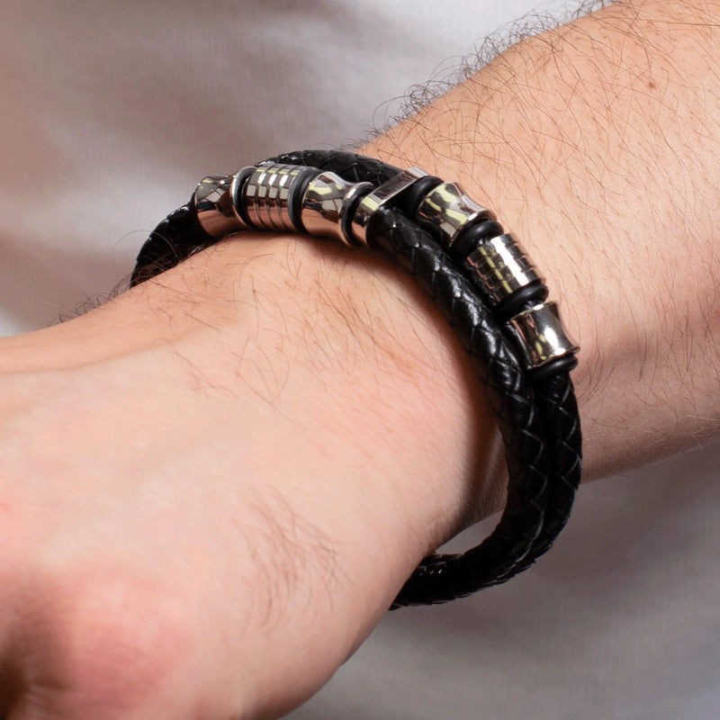 Black leather bracelet with metallic cylindrical beads.