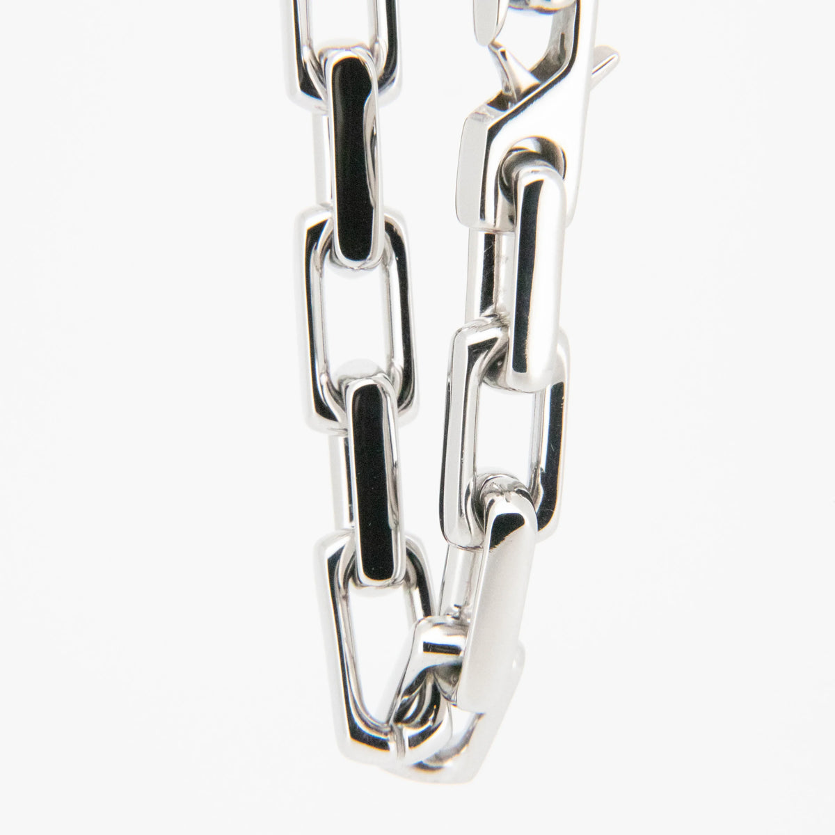 Silver metal chain with rectangular links.