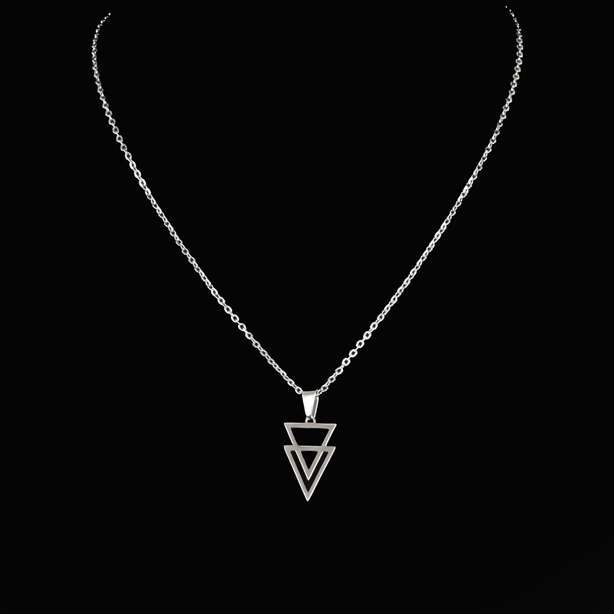 Silver necklace with a geometric triangle pendant.