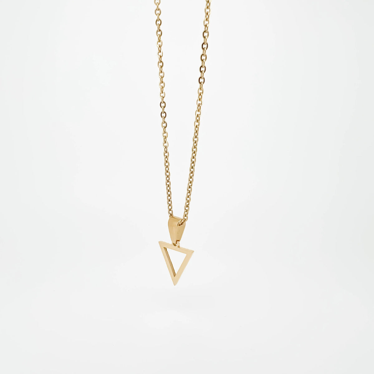 Gold necklace with a triangular pendant.