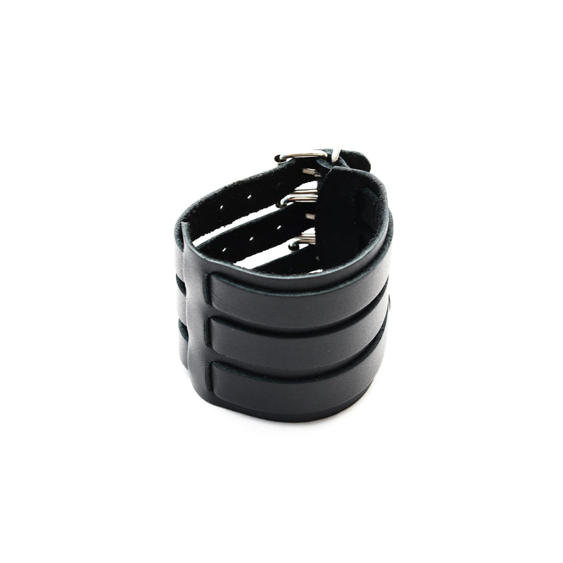 Black leather cuff bracelet with three horizontal bands and a buckle closure.