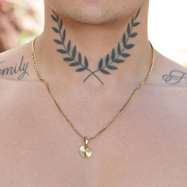 Tattoo of crossed laurel branches on a person’s neck.