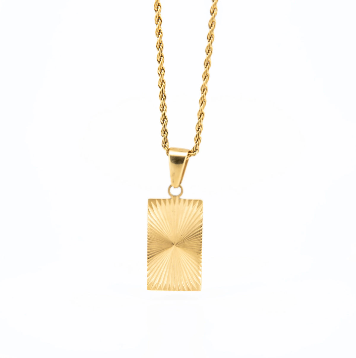 Gold pendant necklace with a rectangular charm featuring a sunburst pattern.