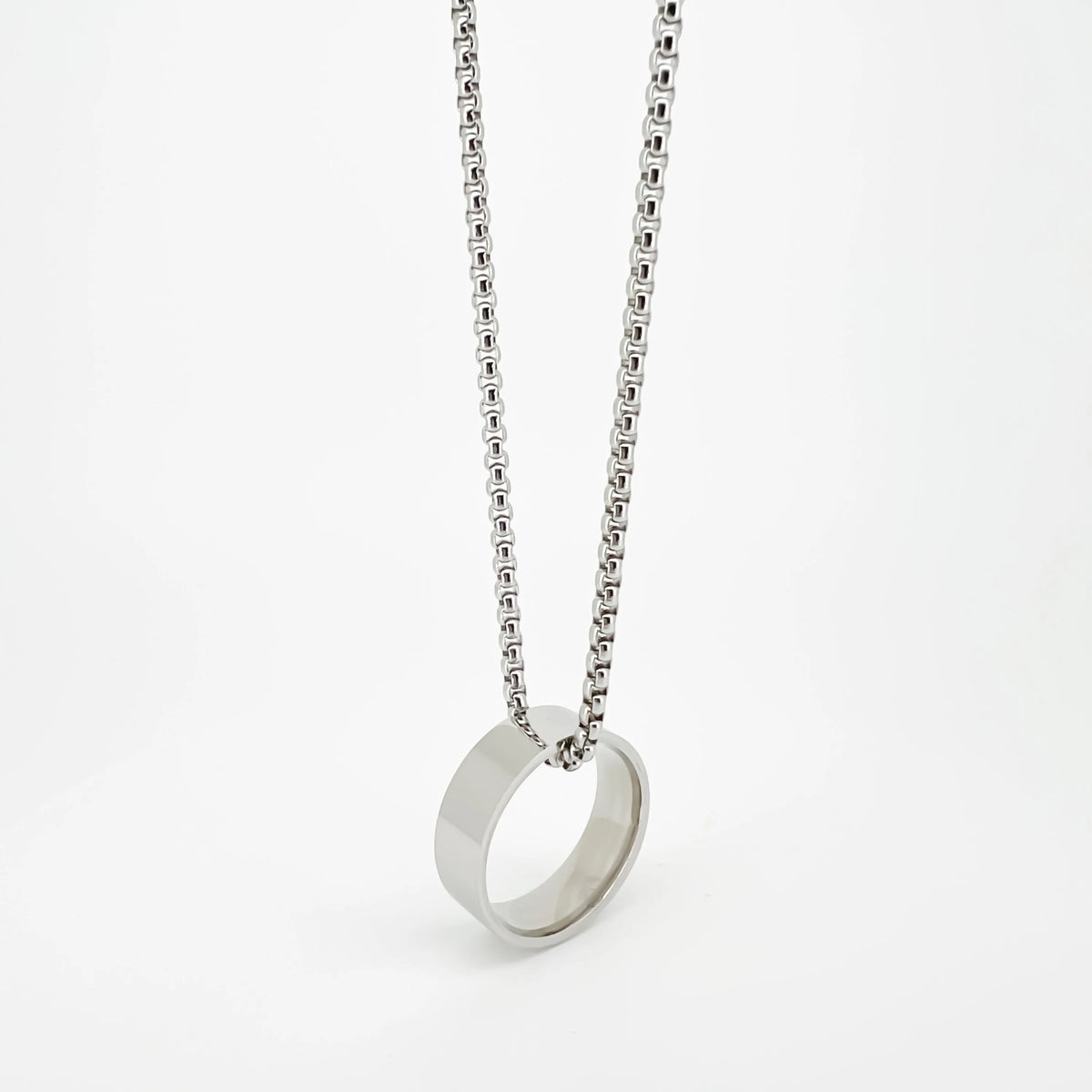 Silver ring pendant on a delicate chain necklace.