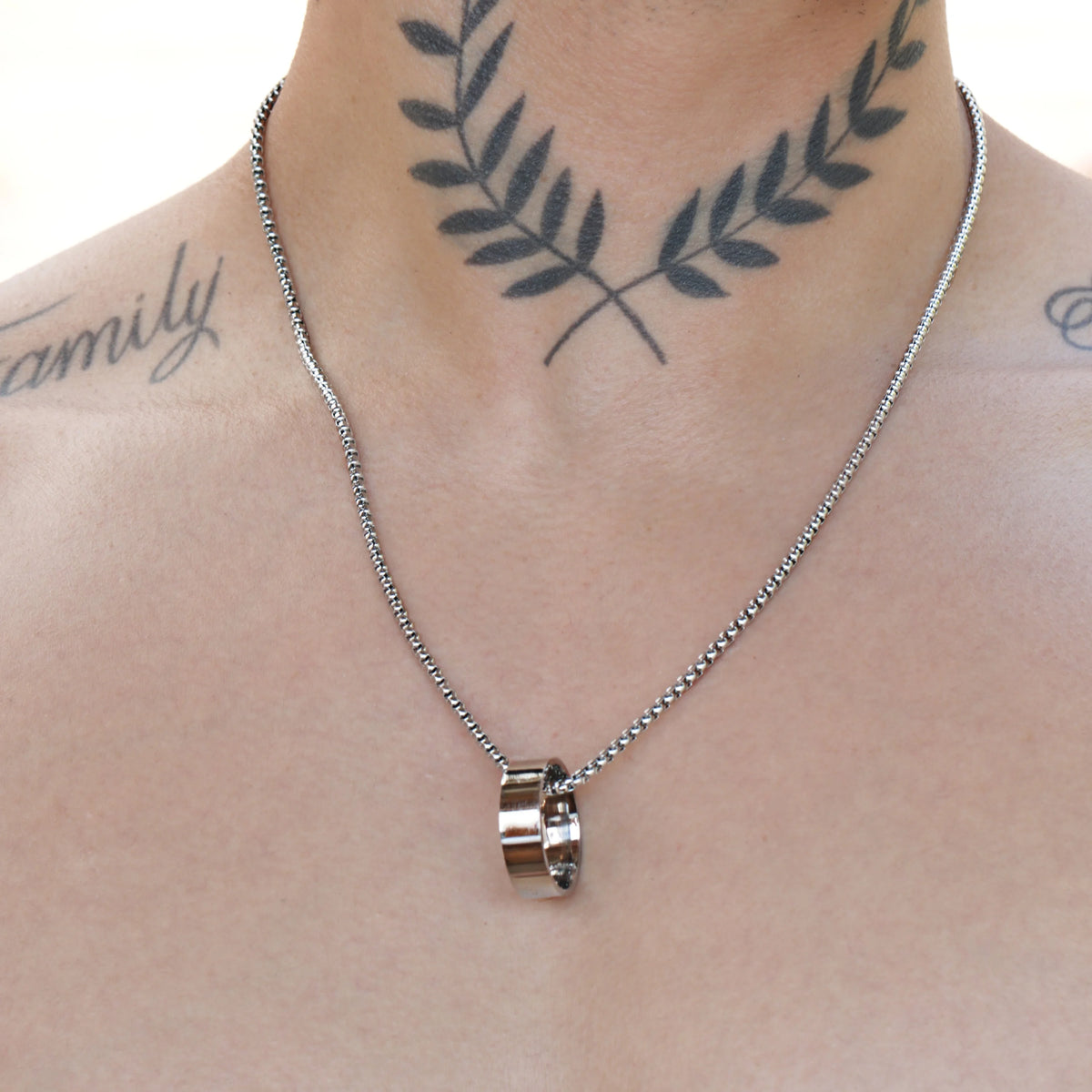 Silver necklace with a ring-shaped pendant.