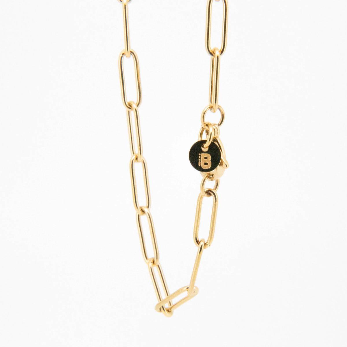 Gold chain necklace with black charm.