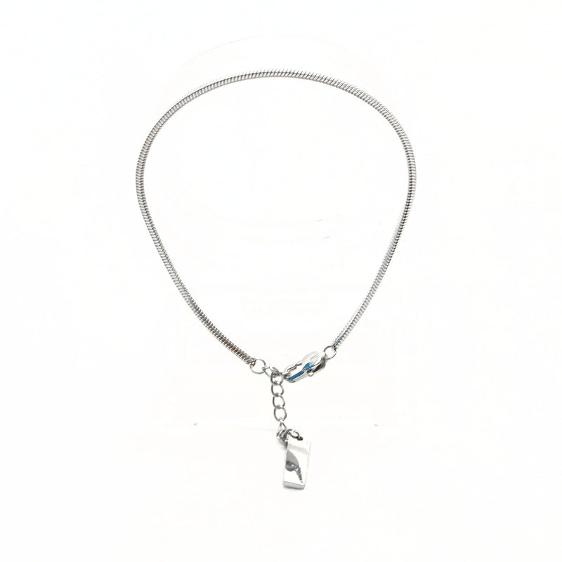 Silver snake chain necklace with a small pendant charm.