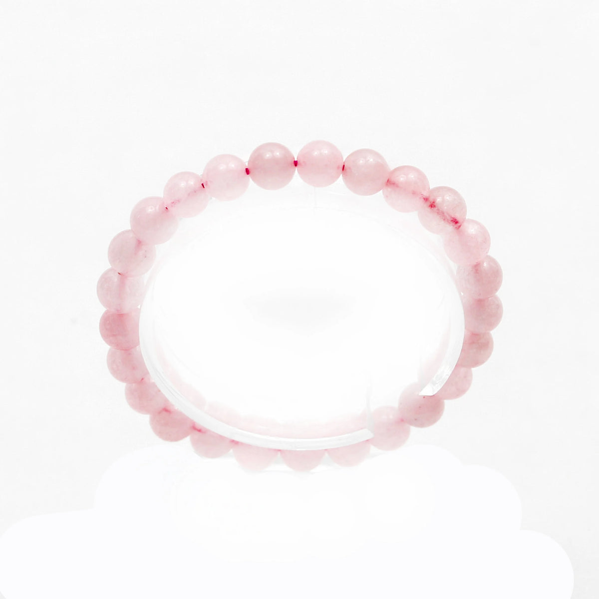 Pink beaded bracelet with round, translucent stones.