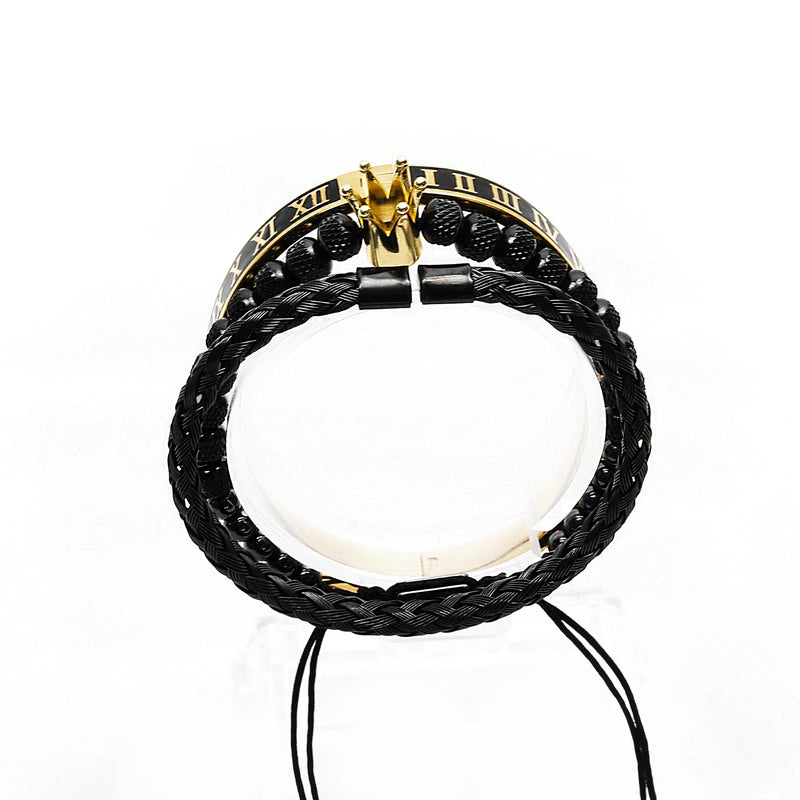 Black braided leather bracelet with a gold and black Roman numeral centerpiece.