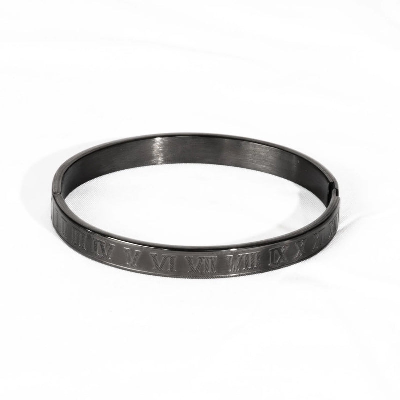 Metallic bangle bracelet with engraved Roman numerals.