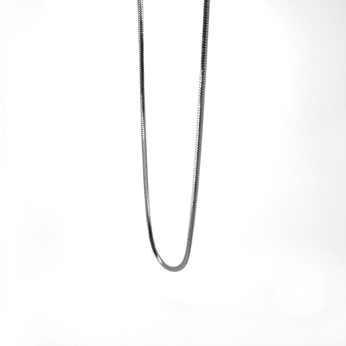 Silver chain necklace with a thin, snake-like design.