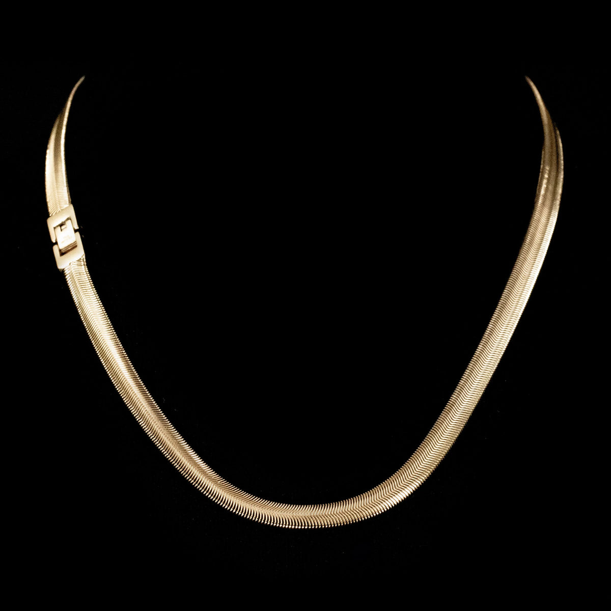 Gold-toned snake chain necklace with a sleek, flexible design.