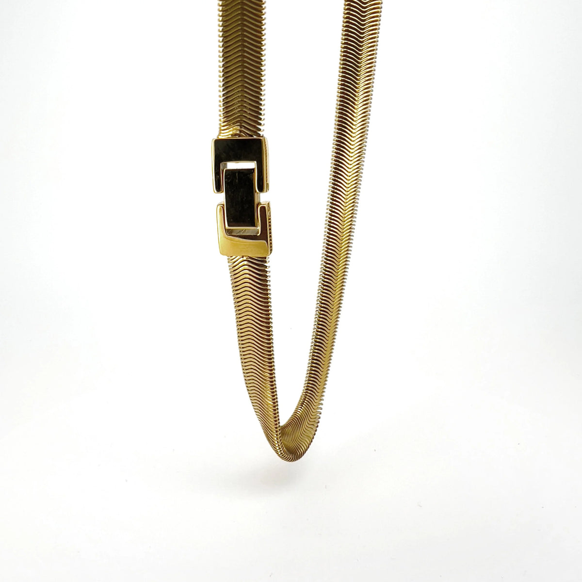 Gold-toned metal chain necklace with a flat, flexible design and a rectangular clasp.