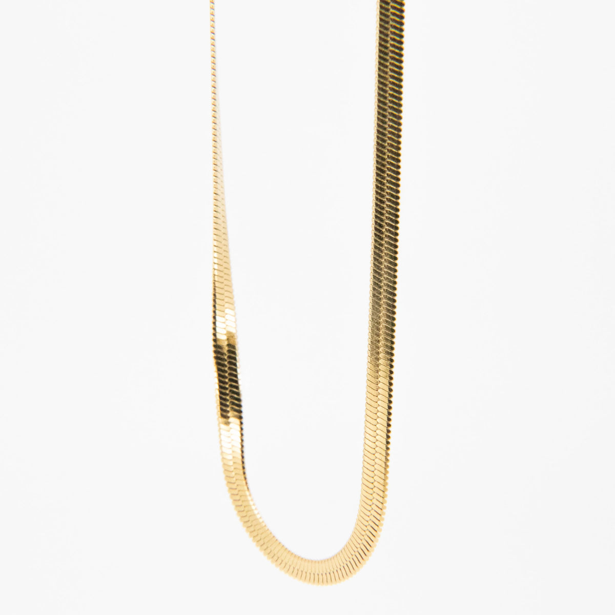 Gold herringbone chain necklace.