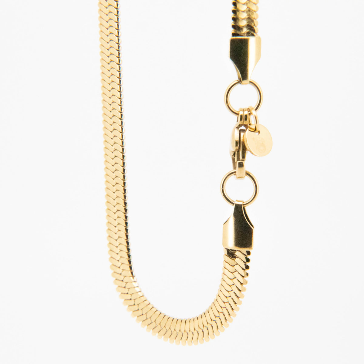 Gold-toned snake chain necklace with clasp and heart charm.