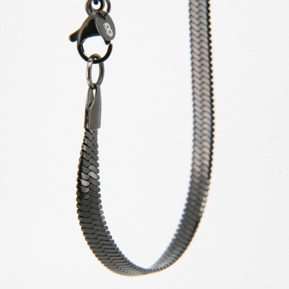 Metal chain necklace with overlapping scale-like links.