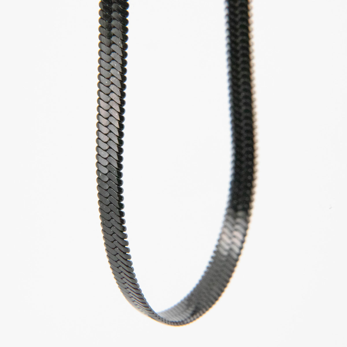 Black rubber belt with a textured zigzag pattern.