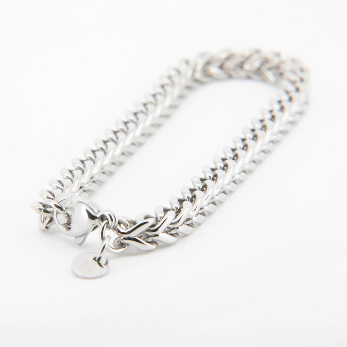 Silver chain bracelet with a heart charm pendant.