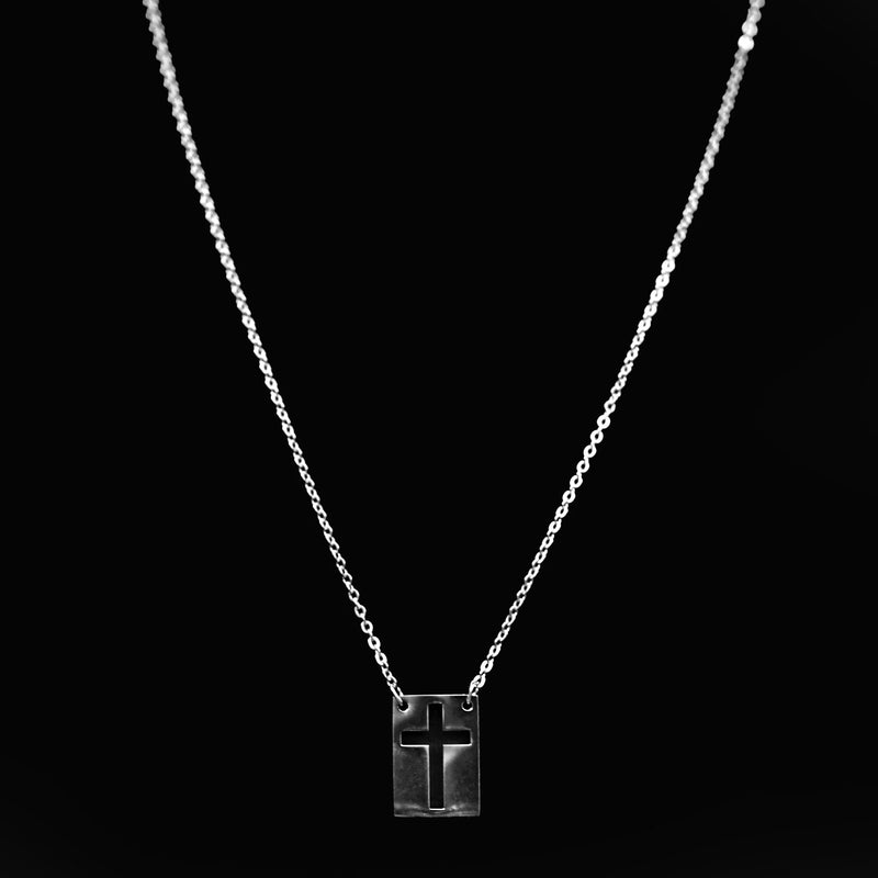 Silver necklace with a rectangular pendant featuring a cross design.