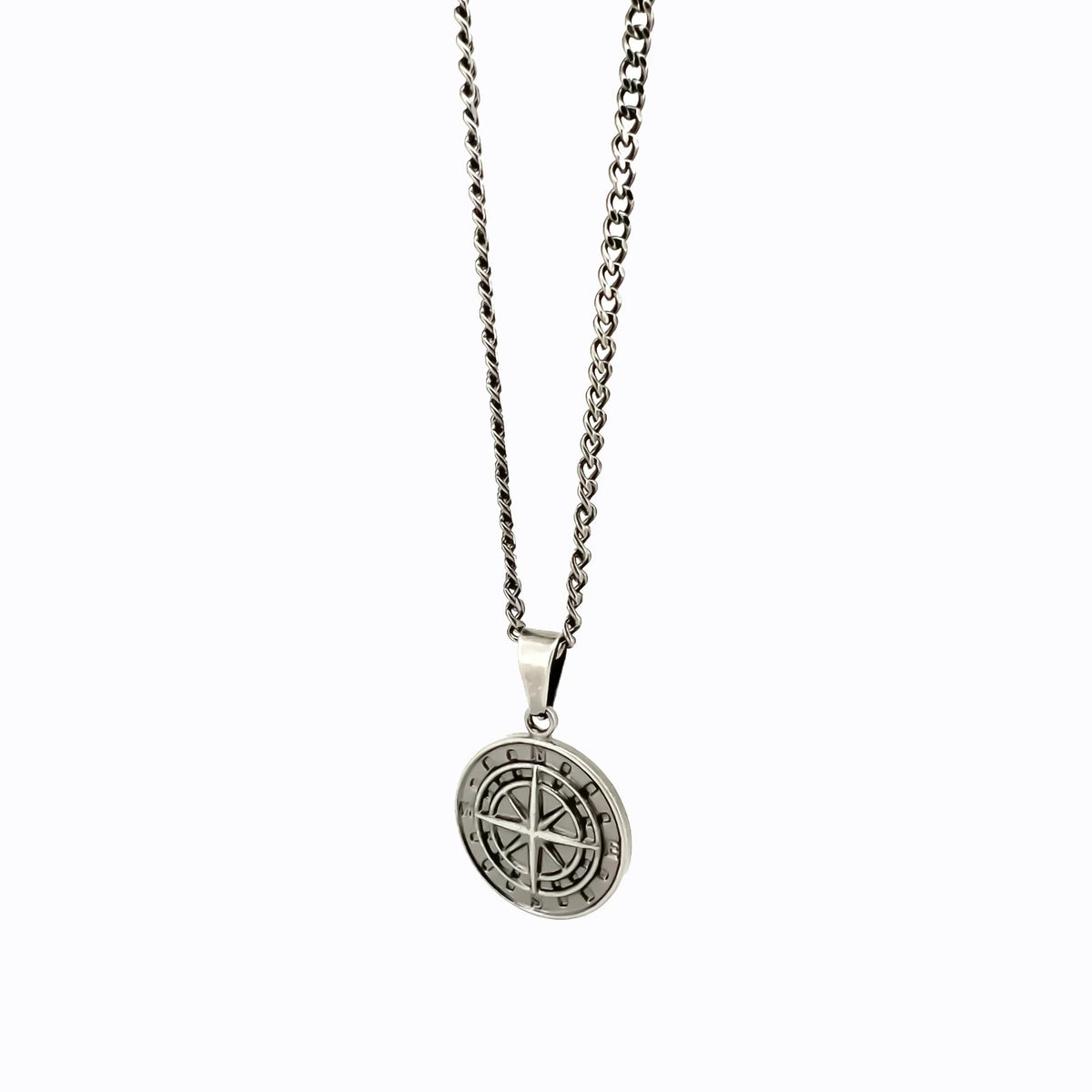 Silver pendant necklace featuring a circular medallion with a compass rose design.