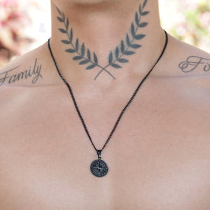 Black pendant necklace with a circular medallion design.