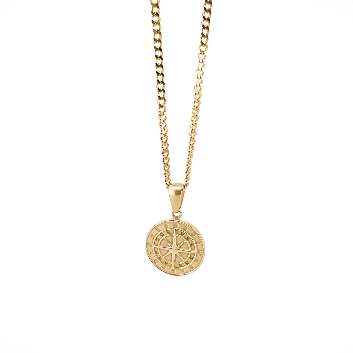 Gold pendant necklace featuring a circular medallion with a compass rose design.