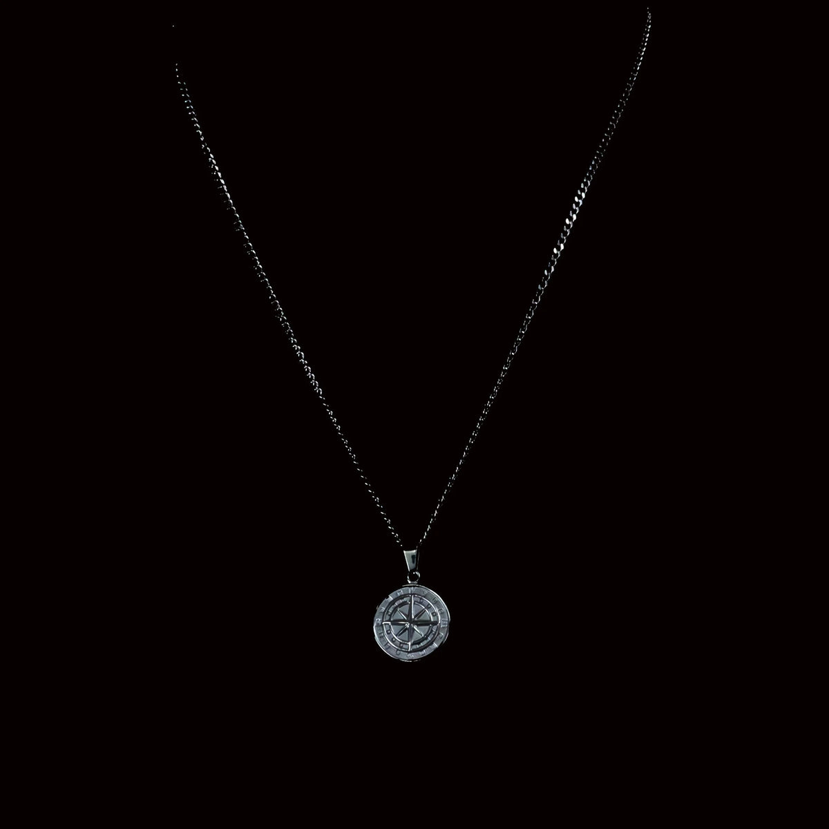 Compass pendant necklace with a delicate chain.