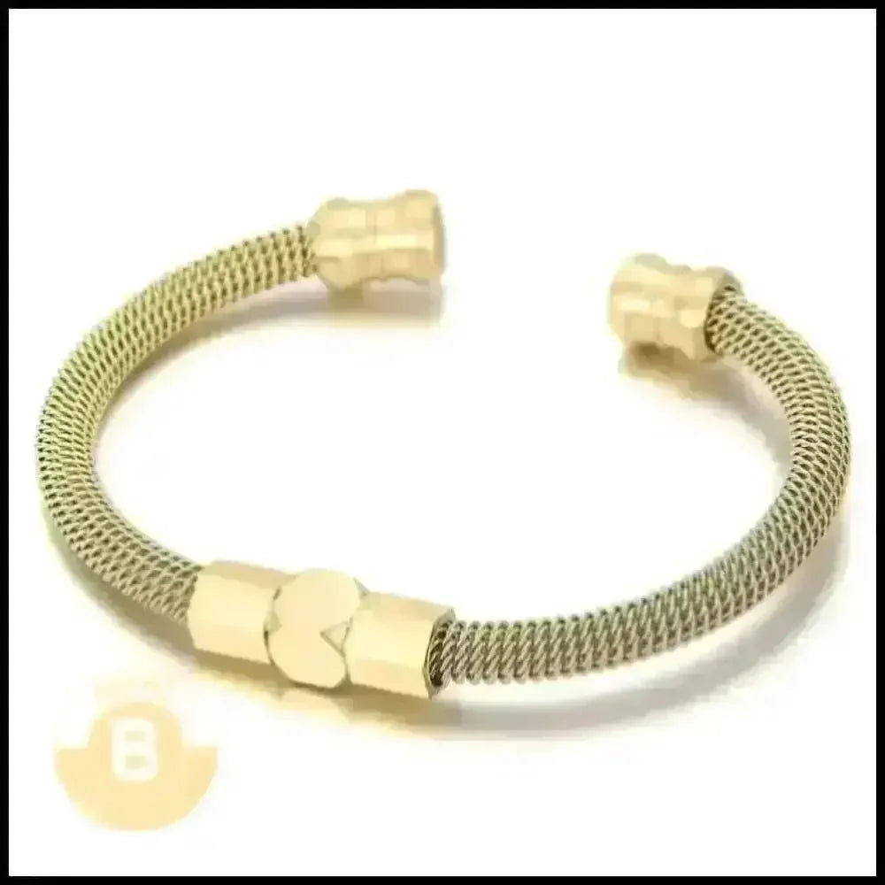 Gold-toned metal bracelet with a coiled wire design and hexagonal end caps.