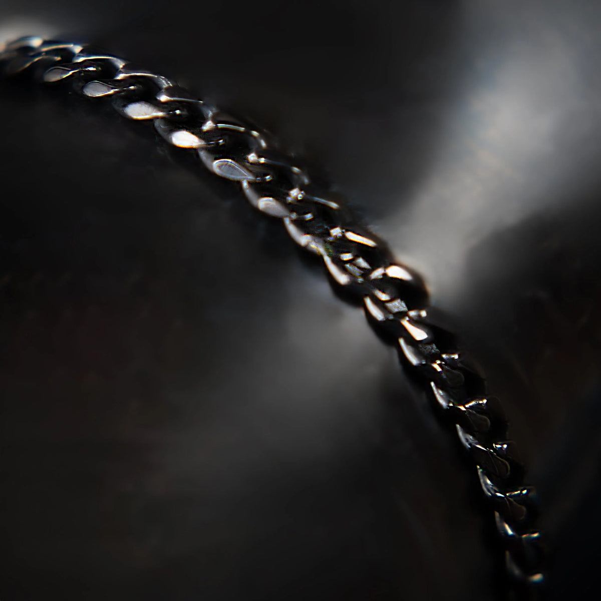 Metallic chain with interlocking links in sharp focus.