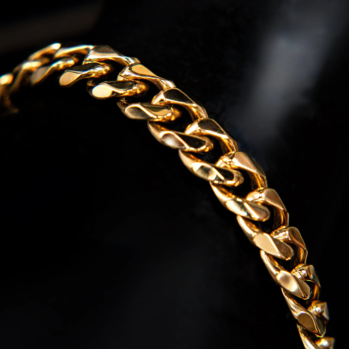 Gold chain bracelet with interlocking links.