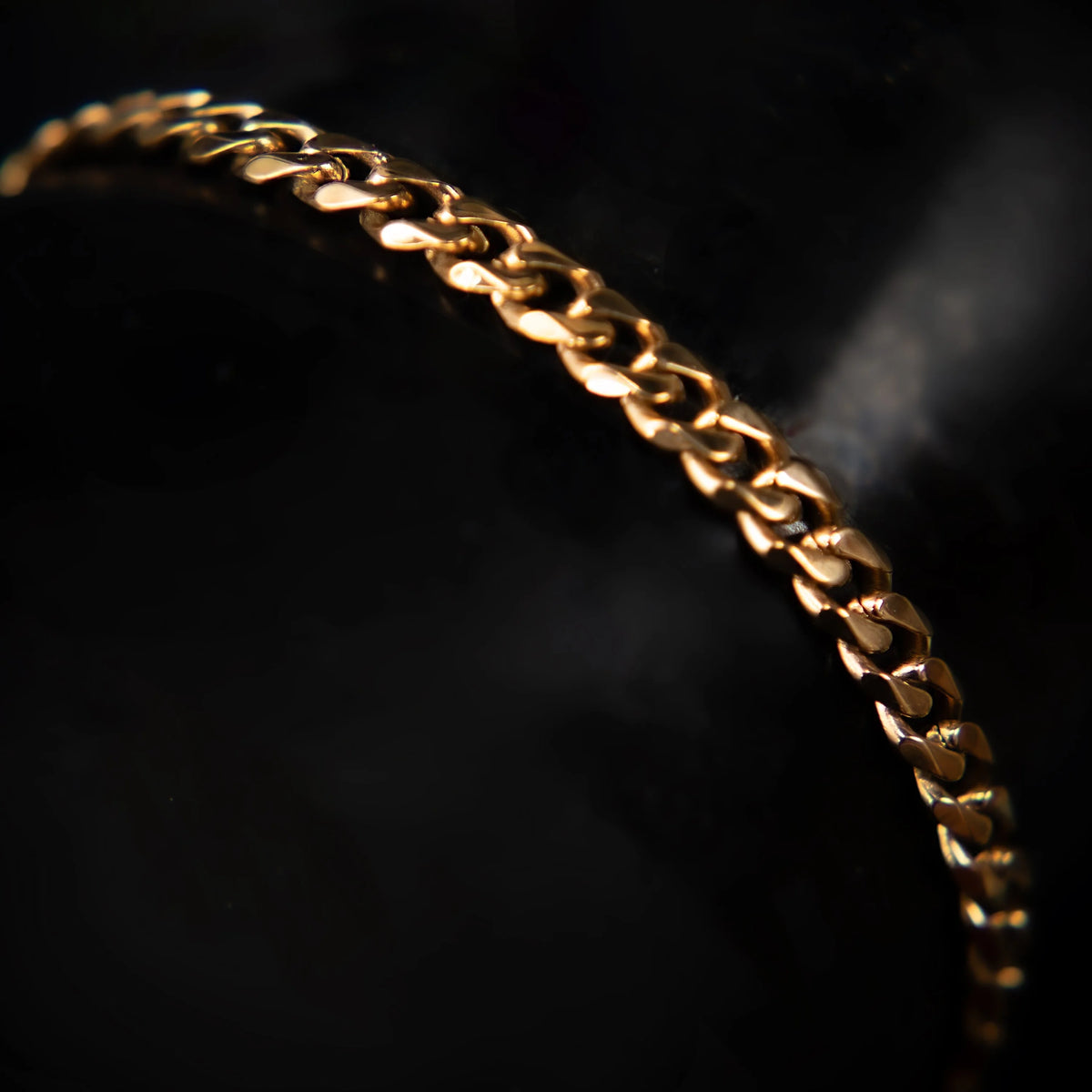 Gold chain bracelet with interlocking links.