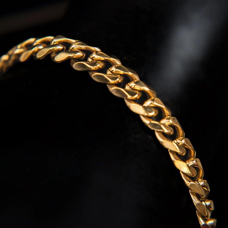 Gold chain bracelet with interlocking links.