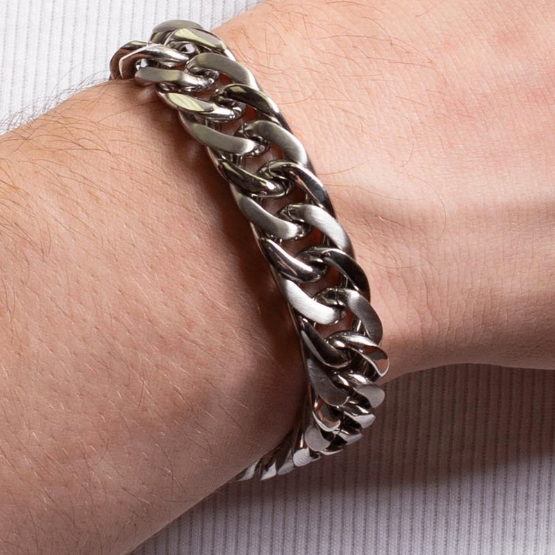 Silver chain bracelet worn on a wrist.