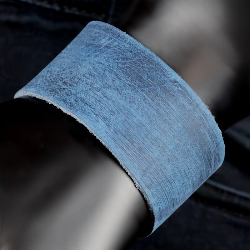 Curved piece of blue-tinted fiberglass or similar fibrous material.