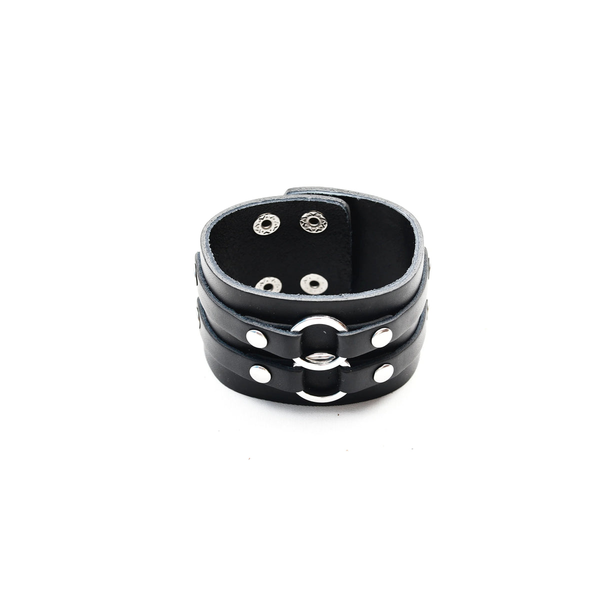 Black leather cuff bracelet with metal rings and studs.