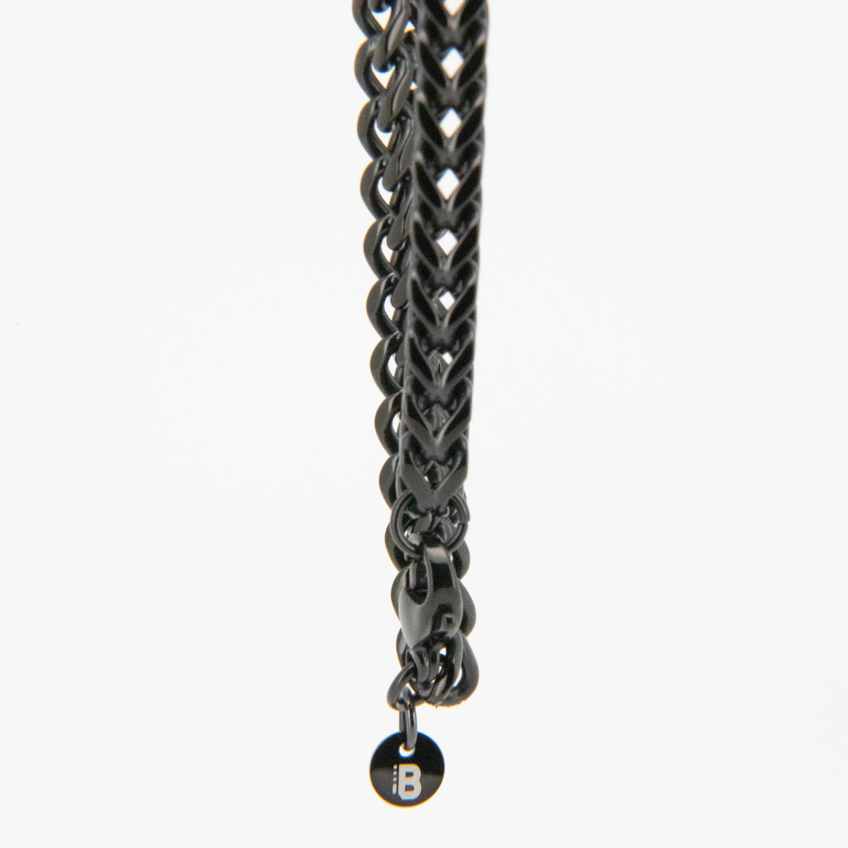 Dark metallic chain with a small pendant or charm at the end.