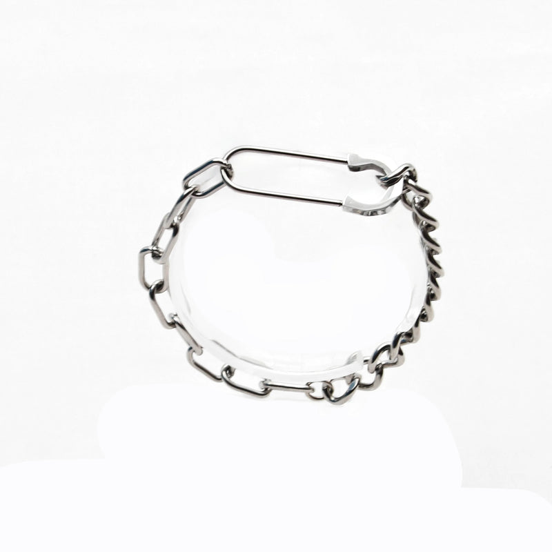 Silver chain bracelet with various link shapes and sizes.