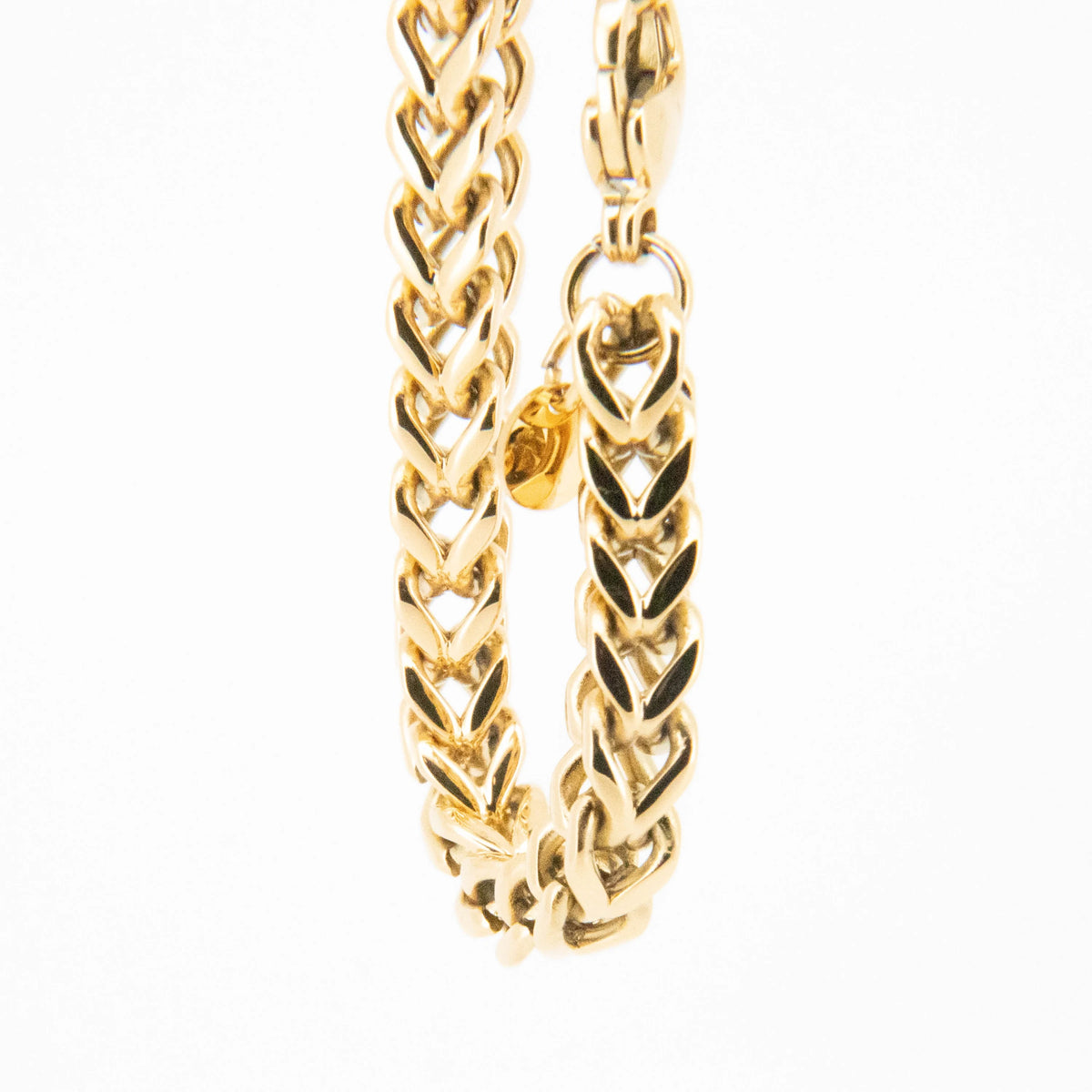 Gold chain necklace with a braided chevron pattern.