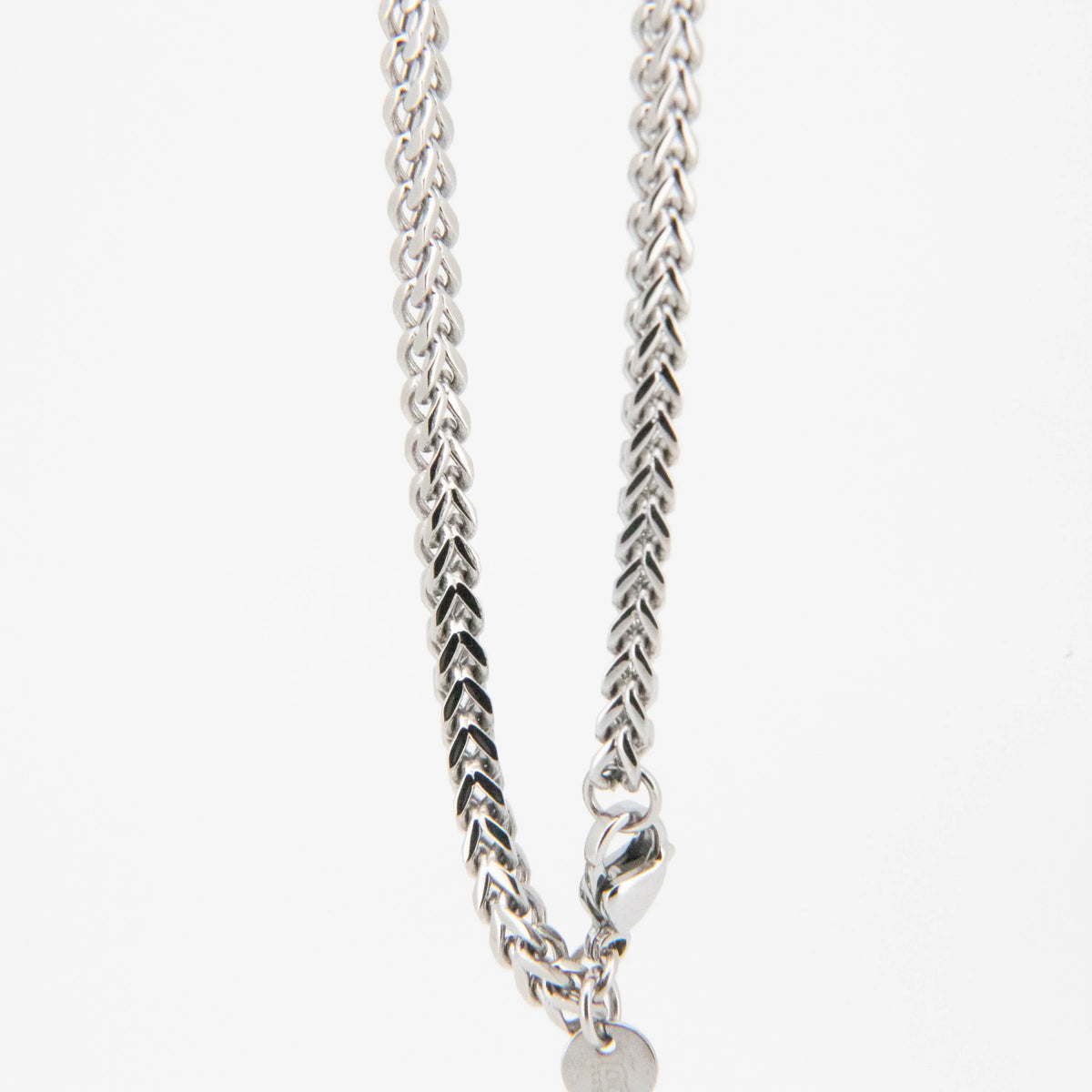 Silver chain necklace with a braided pattern and lobster clasp.