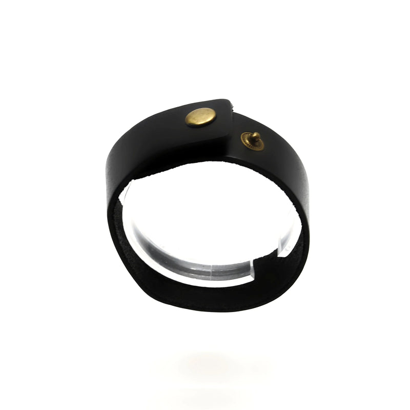 Black leather ring or bracelet with gold-colored studs.