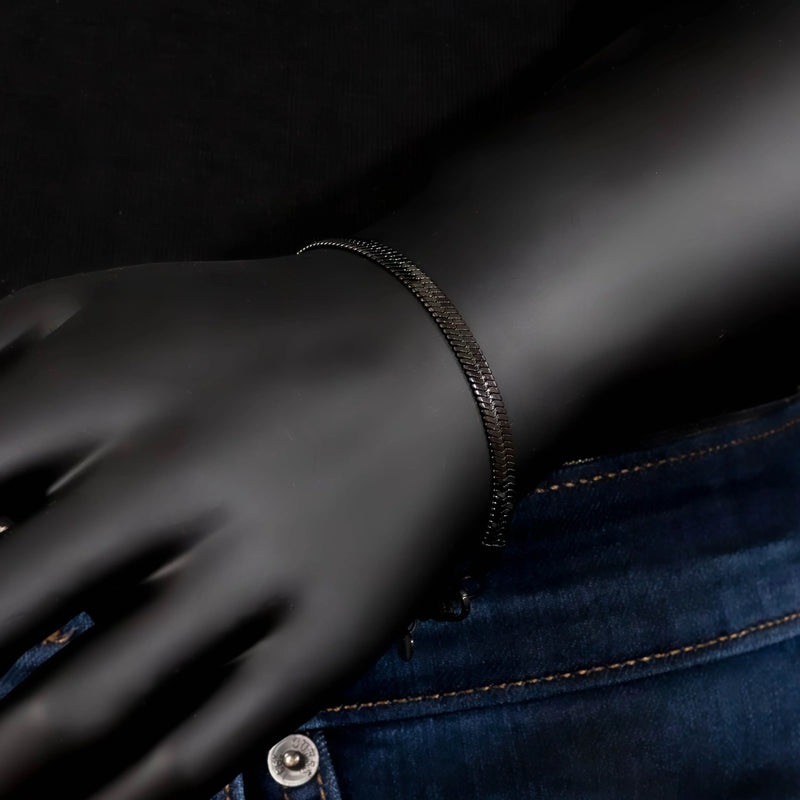 Black latex or nitrile glove with a bracelet on the wrist.